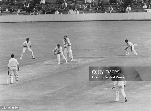 Wicketkeeper Farokh Engineer of India looks on from behind the stumps as John Edrich of England is bowled off a delivery by Bhagwath Chandrasekhar of...