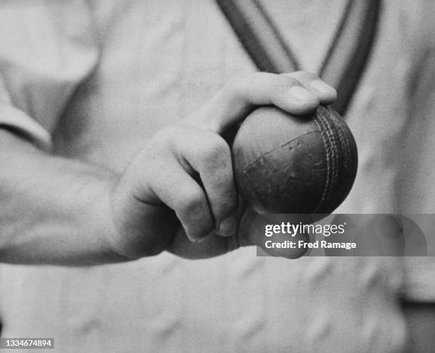 Bill Edrich of England, right-handed batsman and right-arm fast bowler for the Middlesex County Cricket Club demonstrates his grip technique with the...