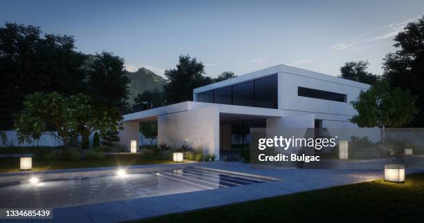 modern family villa (evening) - garden lighting stock pictures, royalty-free photos & images