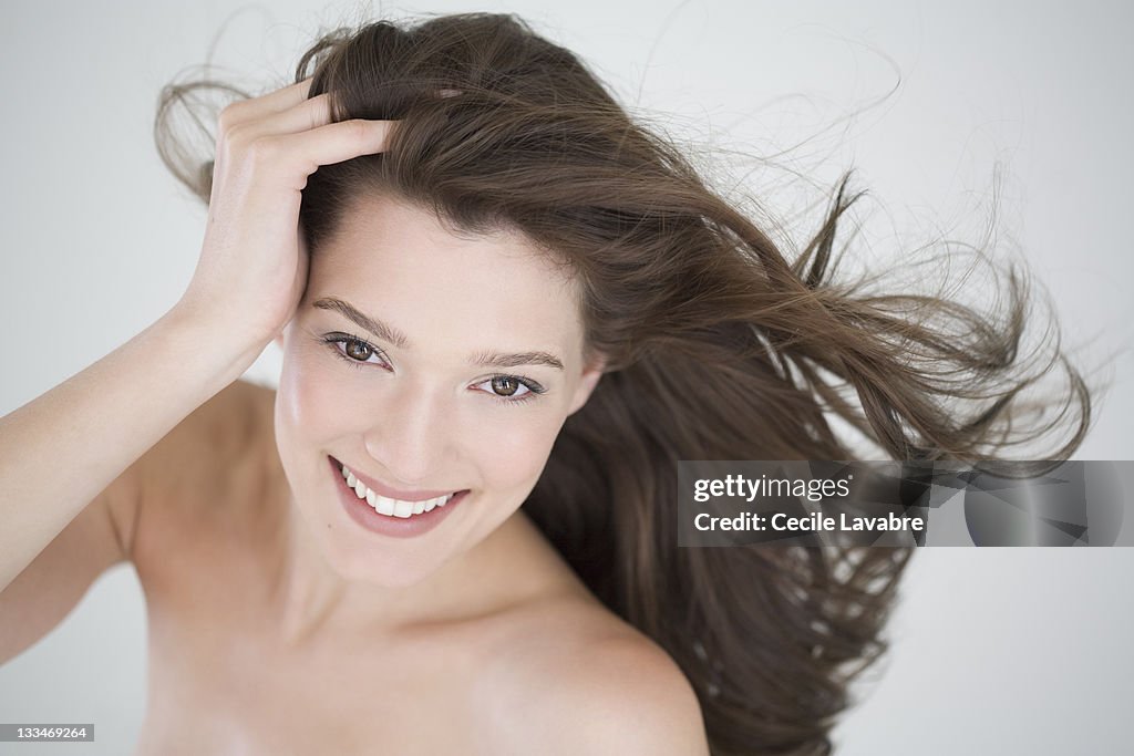 Portrait of a young woman with windblown hair