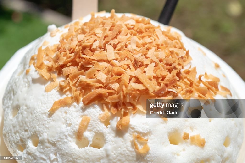 Compacted Shaved Ice Shave ice topped with Snow Cap and toasted coconut at Ululani's Shave ...