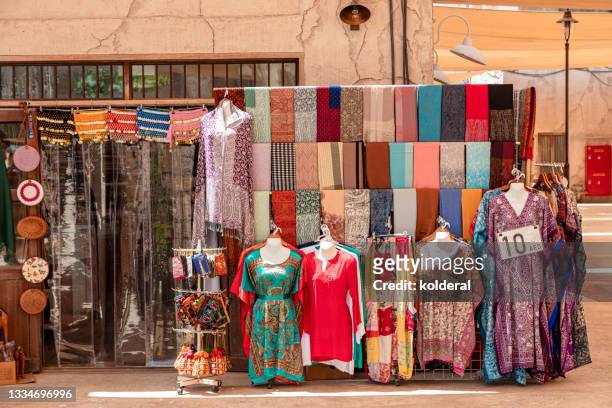 traditional textile store in dubai - souk stock pictures, royalty-free photos & images