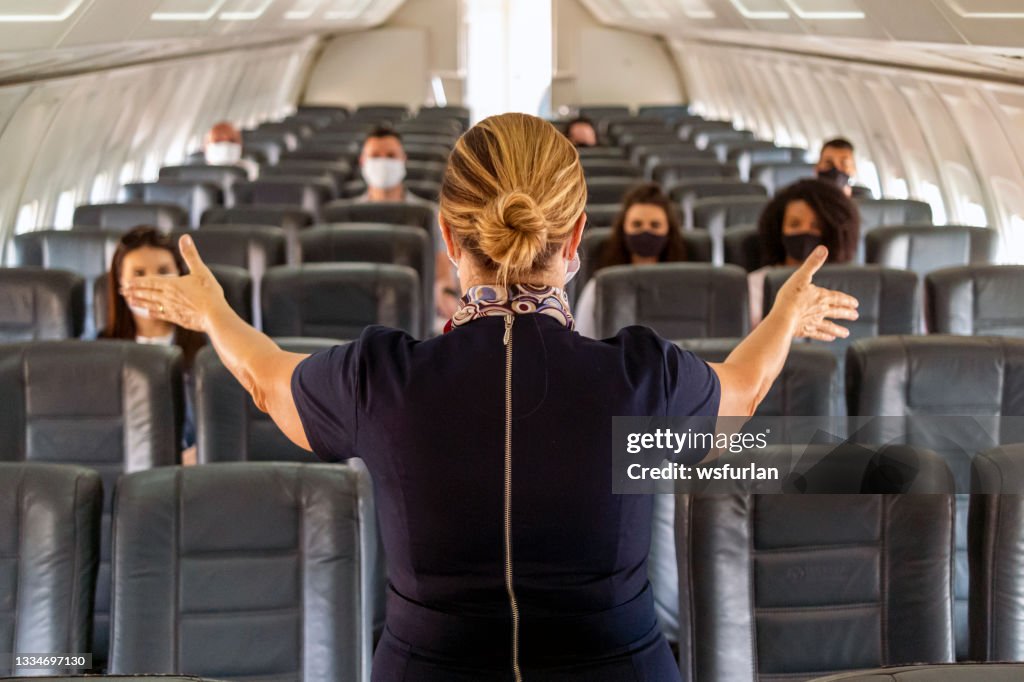 Flight attendant inside an aircraft.