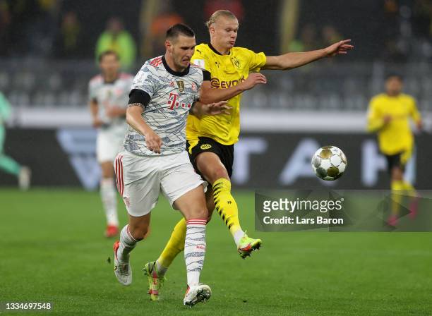 Niklas Süle of FC Bayern München challenges Erling Haaland of Borussia Dortmund during the Supercup 2021 match between FC Bayern München and Borussia...