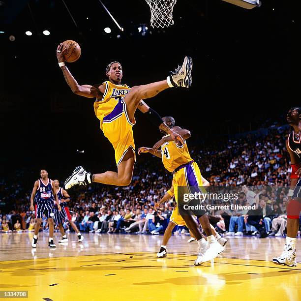 Dennis Rodman the Los Angeles Lakers grabs a rebound against the Houston Rockets during an NBA game at the Staples Center in Los Angeles, California....