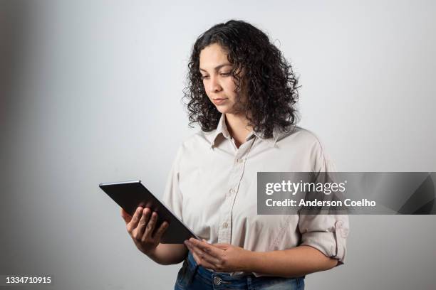 latin woman over 30 years old posing in studio, with tablet - woman 30 years old portrait stock pictures, royalty-free photos & images