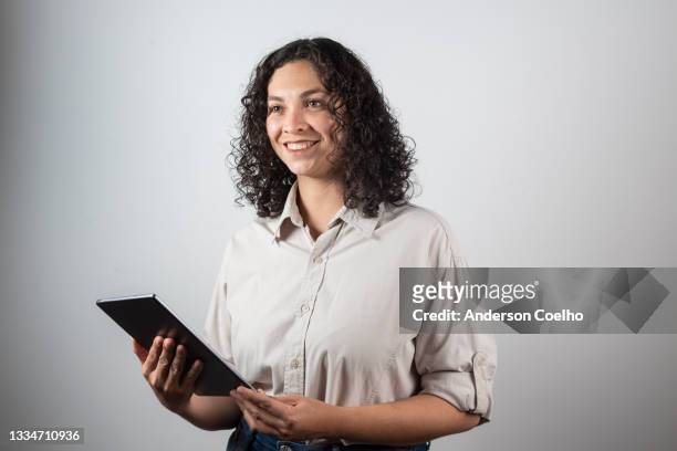 latin woman over 30 years old posing in studio, with tablet - 30 34 years stock pictures, royalty-free photos & images