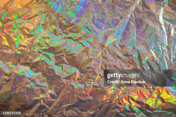 crumpled colorful holographic iridescent background. trendy textured metallic backdrop. - iridescent stockfoto's en -beelden