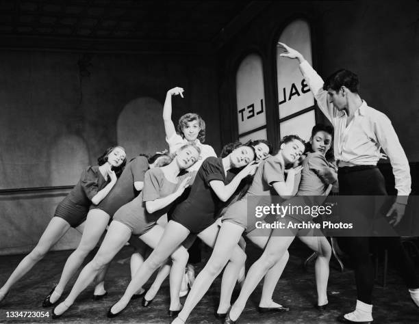 American actress, dancer and comedian Nancy Walker standing among a group of unspecified dancers, with American actor, singer and dancer Harold Lang...