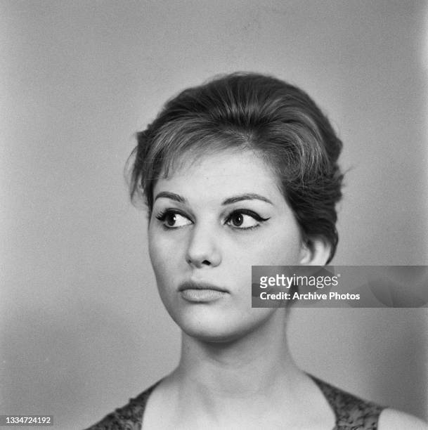 Italian-Tunisian actress Claudia Cardinale, her eyes looking to the left of the frame, in a studio portrait, location unspecified, circa 1962. The...
