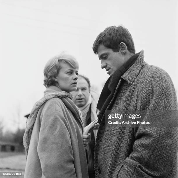 French actress and singer Jeanne Moreau , British theatre and film director Peter Brook, and French actor Jean-Paul Belmondo on the set of 'Moderato...