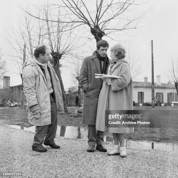 British theatre and film director Peter Brook with French actor Jean-Paul Belmondo and French actress and singer Jeanne Moreau on the set of...