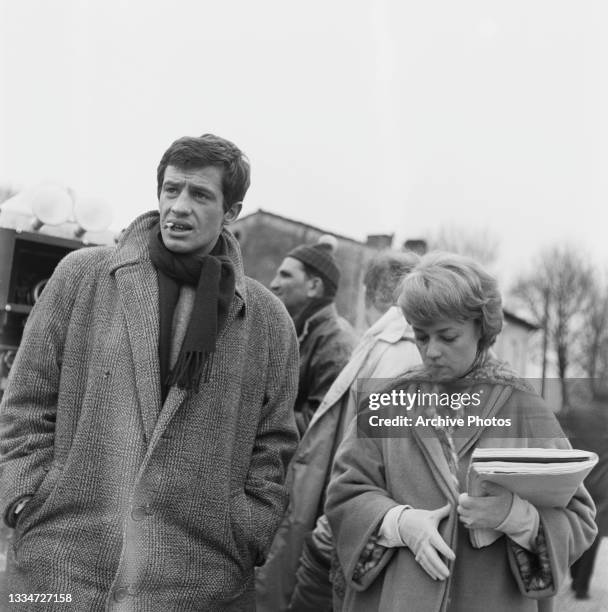 French actor Jean-Paul Belmondo and French actress and singer Jeanne Moreau on the set of 'Moderato cantabile' , location unspecified, 1960. The...