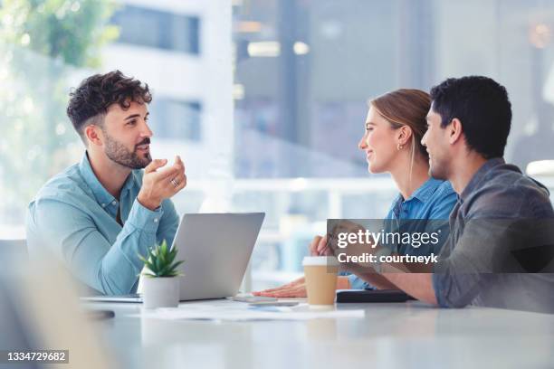 financial advisor with couple explaining options - advice imagens e fotografias de stock