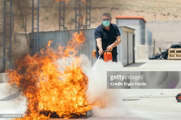 people in the extinguisher training program - fire extinguisher stock pictures, royalty-free photos & images