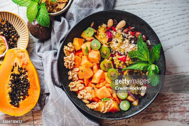 papaya superfood breakfast bowl - raw food diet stock pictures, royalty-free photos & images