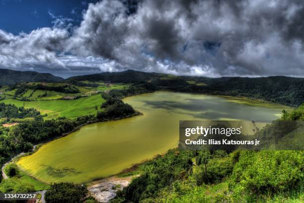 lagoa das furnas green crater lake under cloudy sky, green hills - furnas valley stock pictures, royalty-free photos & images