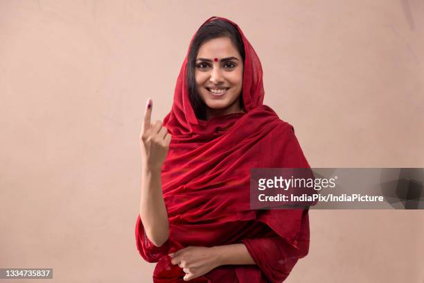 portrait of a woman standing with voters mark. - election stock pictures, royalty-free photos & images