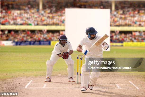 batsman taking a run during a match - batsman stock pictures, royalty-free photos & images