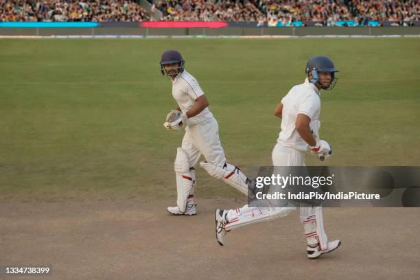 cricketers, batsmen cross eaching other while taking a runduring a match - batsman stock pictures, royalty-free photos & images