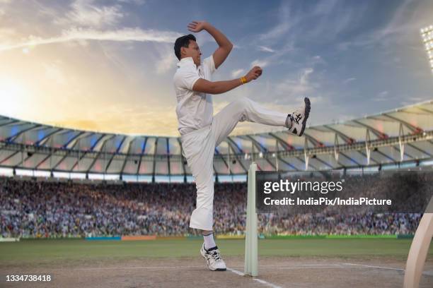 cricketer, bowler bowling during a match - cricket bowler imagens e fotografias de stock