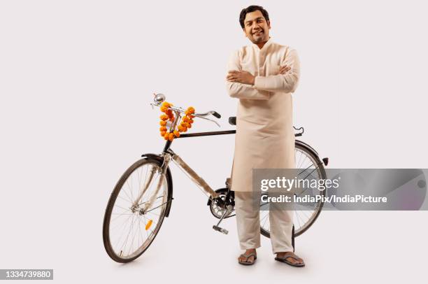 a rural man confidently posing while standing with new bicycle - kurta stock pictures, royalty-free photos & images