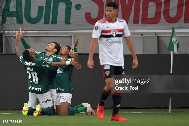Raphael Veiga of Palmeiras celebrates with teammates after scoring the first goal of his team during a quarter final second leg match between...