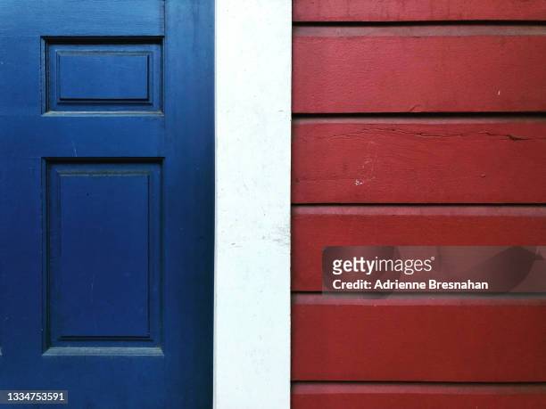 abstract of blue door and red paneled wall - blue house red door stock pictures, royalty-free photos & images