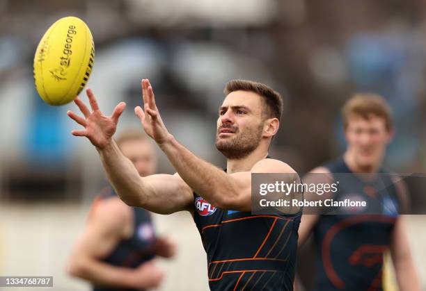 Stephen Coniglio of the Giants takes the ball during a GWS Giants AFL training session at Punt Road Oval on August 18, 2021 in Melbourne, Australia.