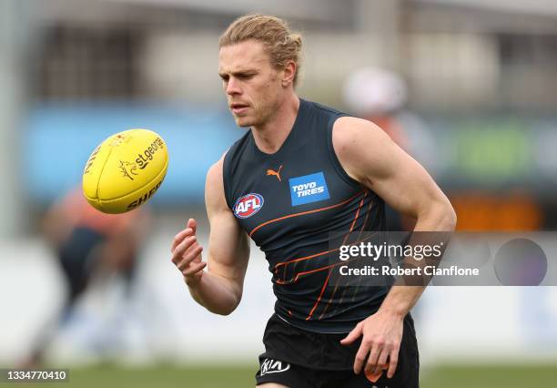 Adam Kennedy of the Giants controls the ball during a GWS Giants AFL training session at Punt Road Oval on August 18, 2021 in Melbourne, Australia.