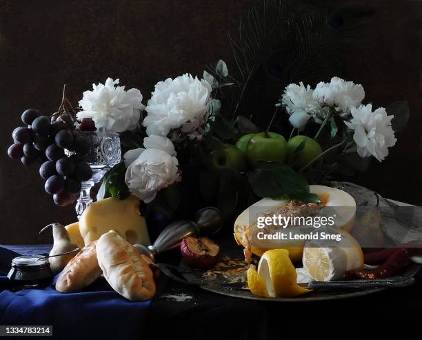 food photography of still life with flowers and fruits front view stylized as a classic dutch (netherlandish) painting on a dark textured background close up - food photography dark background blue stock-fotos und bilder