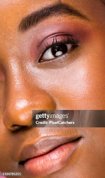 extreme close-up beautiful young woman with pink eyeshadow and pink lips - beautiful woman and eyeshadow stock pictures, royalty-free photos & images