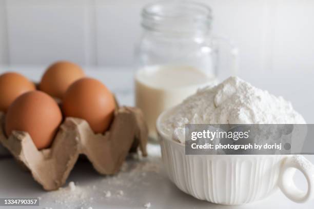 baking ingredients, flour, egg and milk - flour stock pictures, royalty-free photos & images