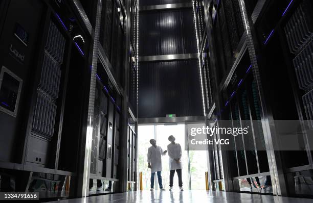 Staff members inspect the phase-change immersion high-performance computing system at Hefei Advanced Computing Center, a major scientific and...