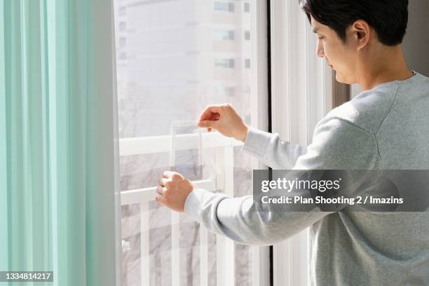 Fix Human Window 14 Window Screen Repair Stock Photos, High-Res Pictures, and Images ...