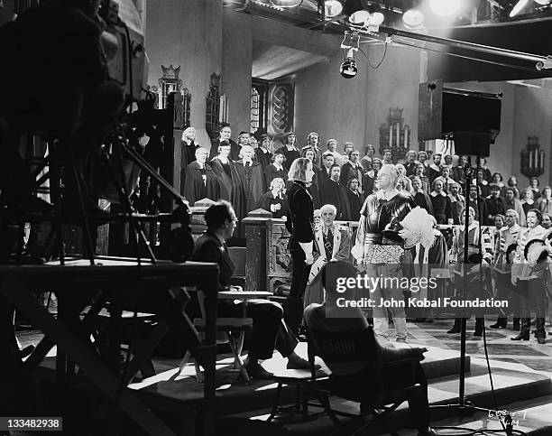 Swedish actress Greta Garbo on the set of the MGM film 'Queen Christina', 25th September 1933. Director Rouben Mamoulian looks on.