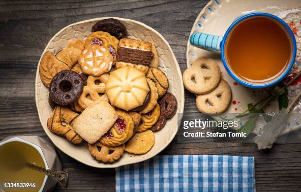 warm cup of tea with tea cookies and biscuits on a plate - cookie stock pictures, royalty-free photos & images
