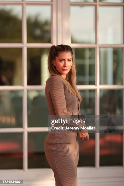 Mrs. Bella wearing brown knit shirt and skirt on August 12, 2021 in Cologne, Germany.