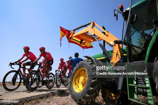 Hugh Carthy of United Kingdom, Jens Keukeleire of Belgium and Team EF Education - Nippo and the Peloton passing in front of a tractor during the 76th...