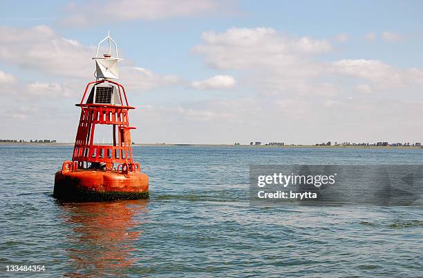 orange buoy in the eastern scheldt,zeeland,the netherlands - buoy stock pictures, royalty-free photos & images