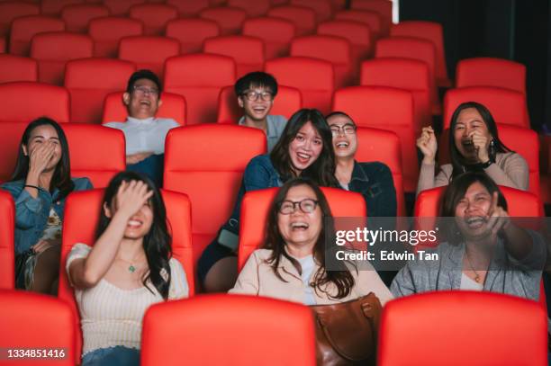 asian chinese audience watching comedy film laughing in the cinema movie theater - girls boys opening night stock pictures, royalty-free photos & images