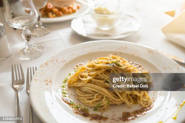 spaghetti with bottarga served on table - italy, sardinia, olbia - botarga a stock pictures, royalty-free photos & images