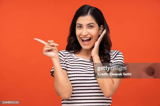 young woman on yellow background - annual woman stock pictures, royalty-free photos & images