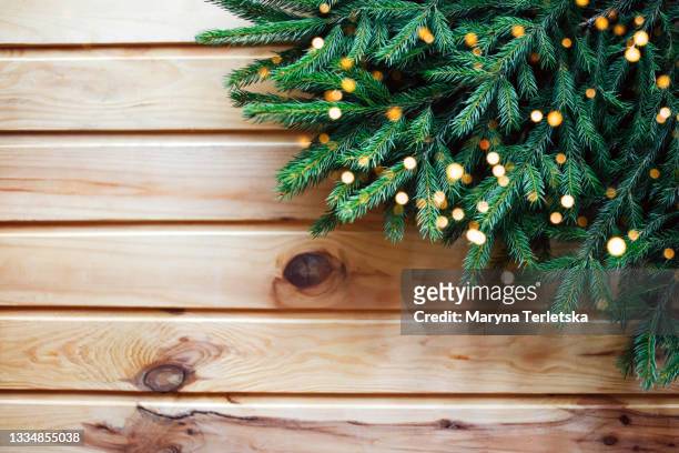 beautiful wooden background with branches of a christmas tree. - christmas toys wooden background stockfoto's en -beelden