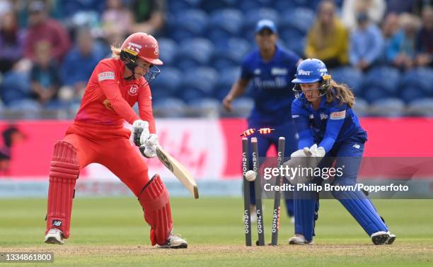 Georgia Redmayne of Welsh Fire is bowled as Tammy Beaumont of London Spirit looks on during The Hundred match between Welsh Fire Women and London...