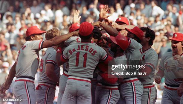 St. Louis Cardinals Jack Clark is surrounded by teammates after hitting pennant-winning home run during playoff series of the Los Angeles Dodgers...