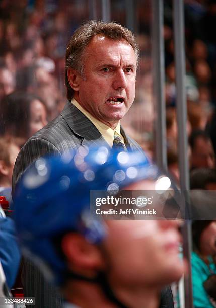 Associate coach Rick Bowness of the Vancouver Canucks looks on from the bench during their NHL Game against the New York Islanders at Rogers Arena...