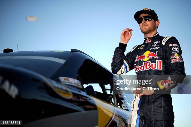 Kasey Kahne, driver of the Red Bull Toyota, stands by his car after qualifying for the NASCAR Sprint Cup Series Ford 400 at Homestead-Miami Speedway...