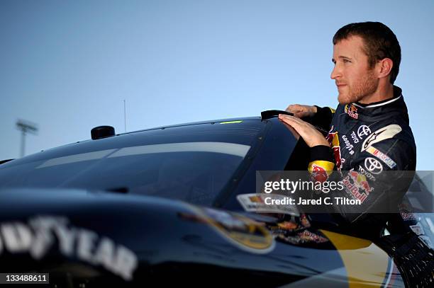 Kasey Kahne, driver of the Red Bull Toyota, climbs out of his car after qualifying for the NASCAR Sprint Cup Series Ford 400 at Homestead-Miami...