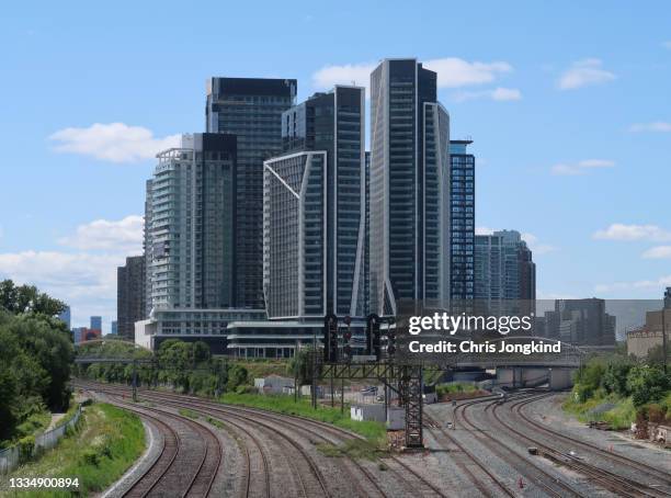 group of residential buildings between railway tracks - toronto condo stock pictures, royalty-free photos & images